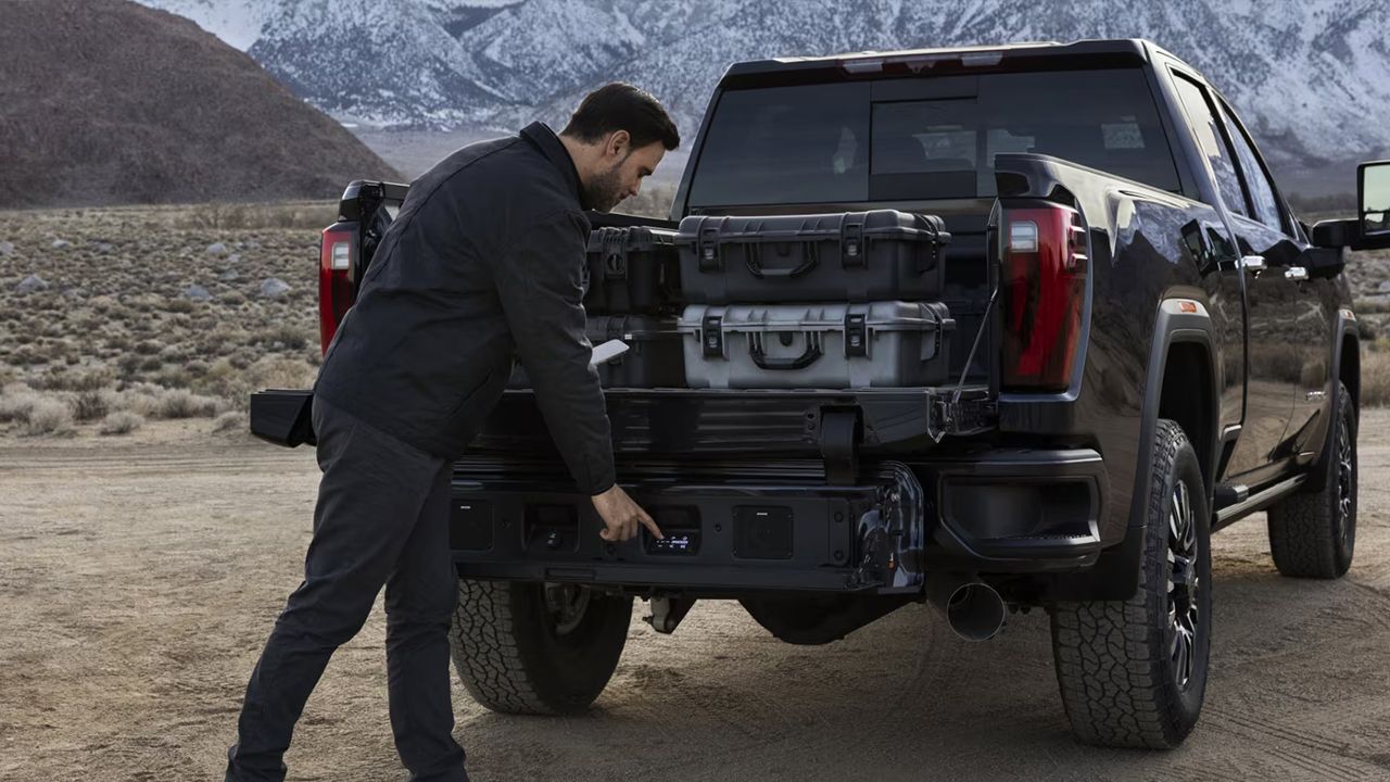 Rear view of a GMC Sierra 2500 HD while boxes are being loaded