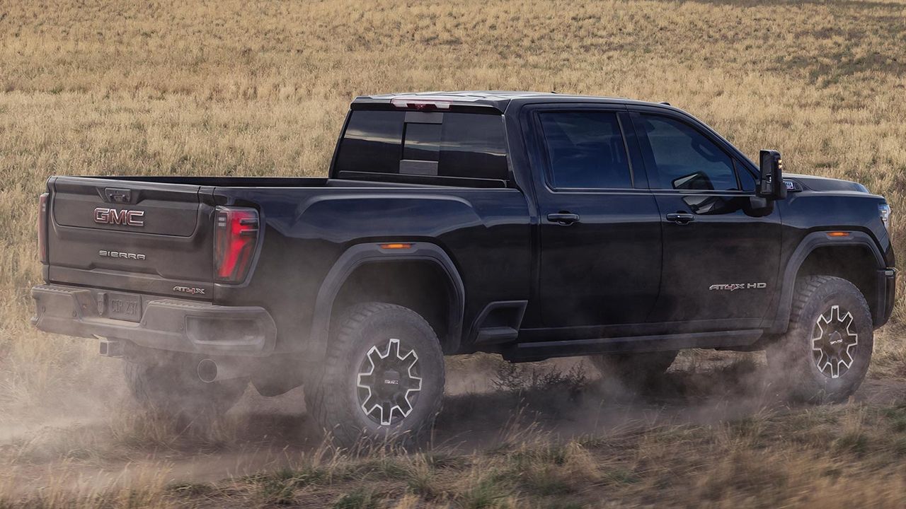 Rear view of a 2026 GMC Sierra 2500 HD on a dirt road