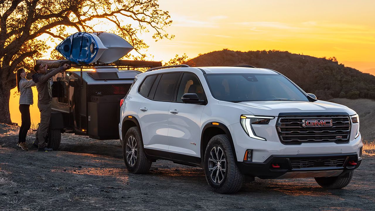 2026 GMC Acadia at sunset with a family and canoe equipment
