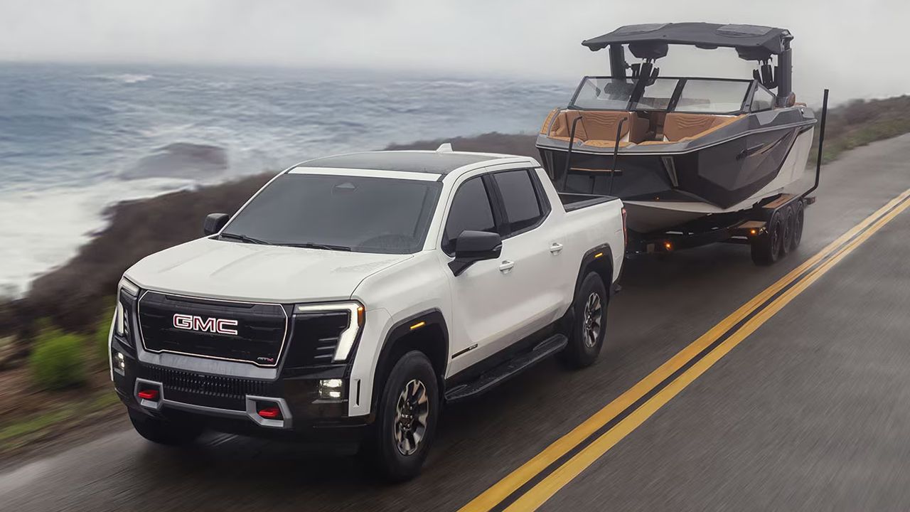 2026 GMC Sierra EV towing a boat